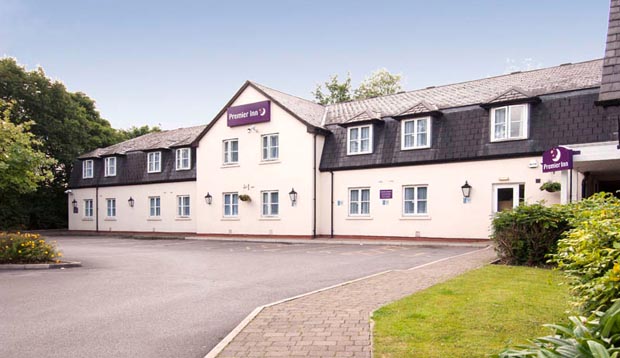 Exterior at Premier Inn Manchester (Handforth) hotel showing surrounding gardens